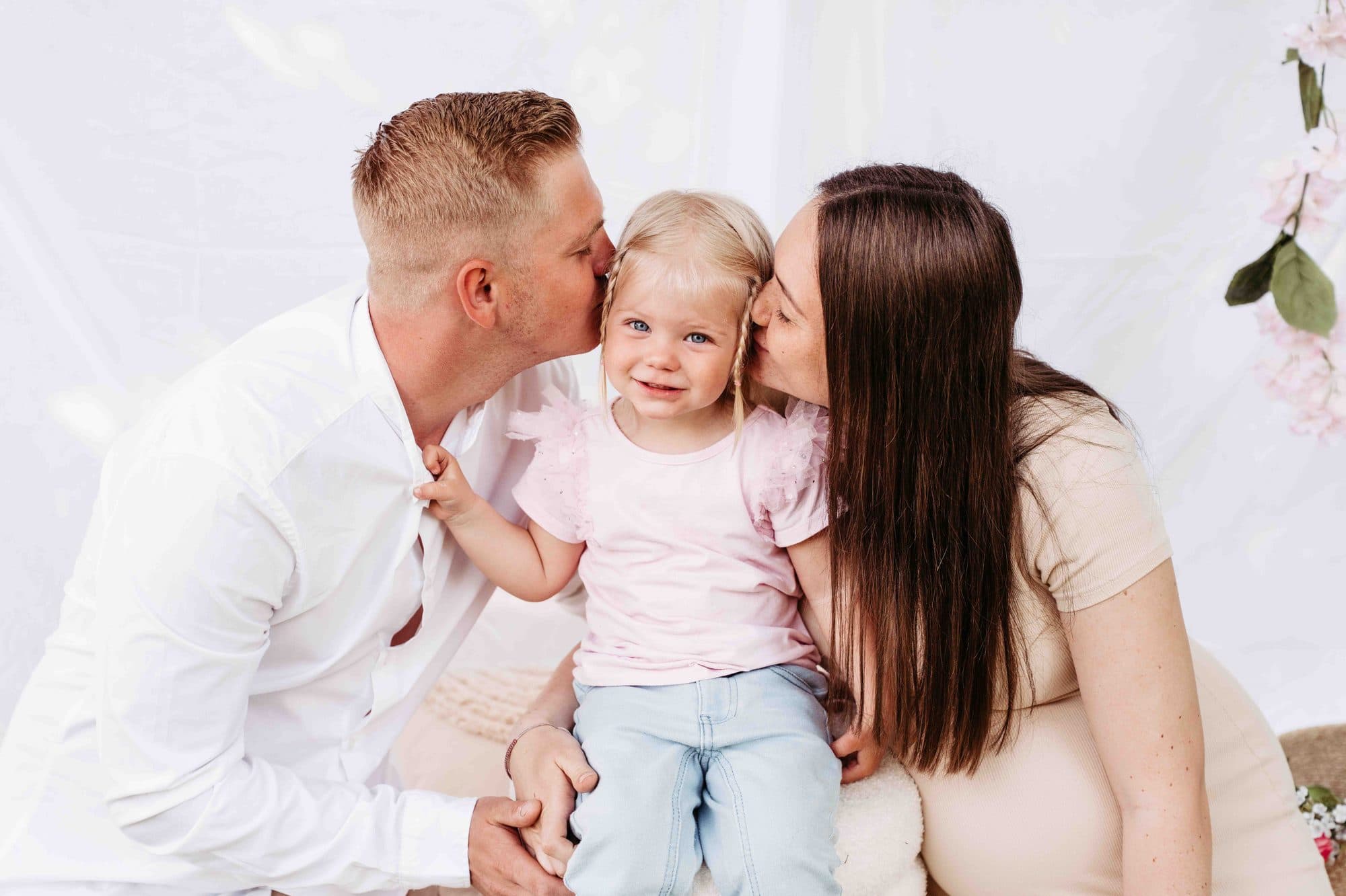 Babybauch Familien Shooting Wien – Eltern küssen Tochter