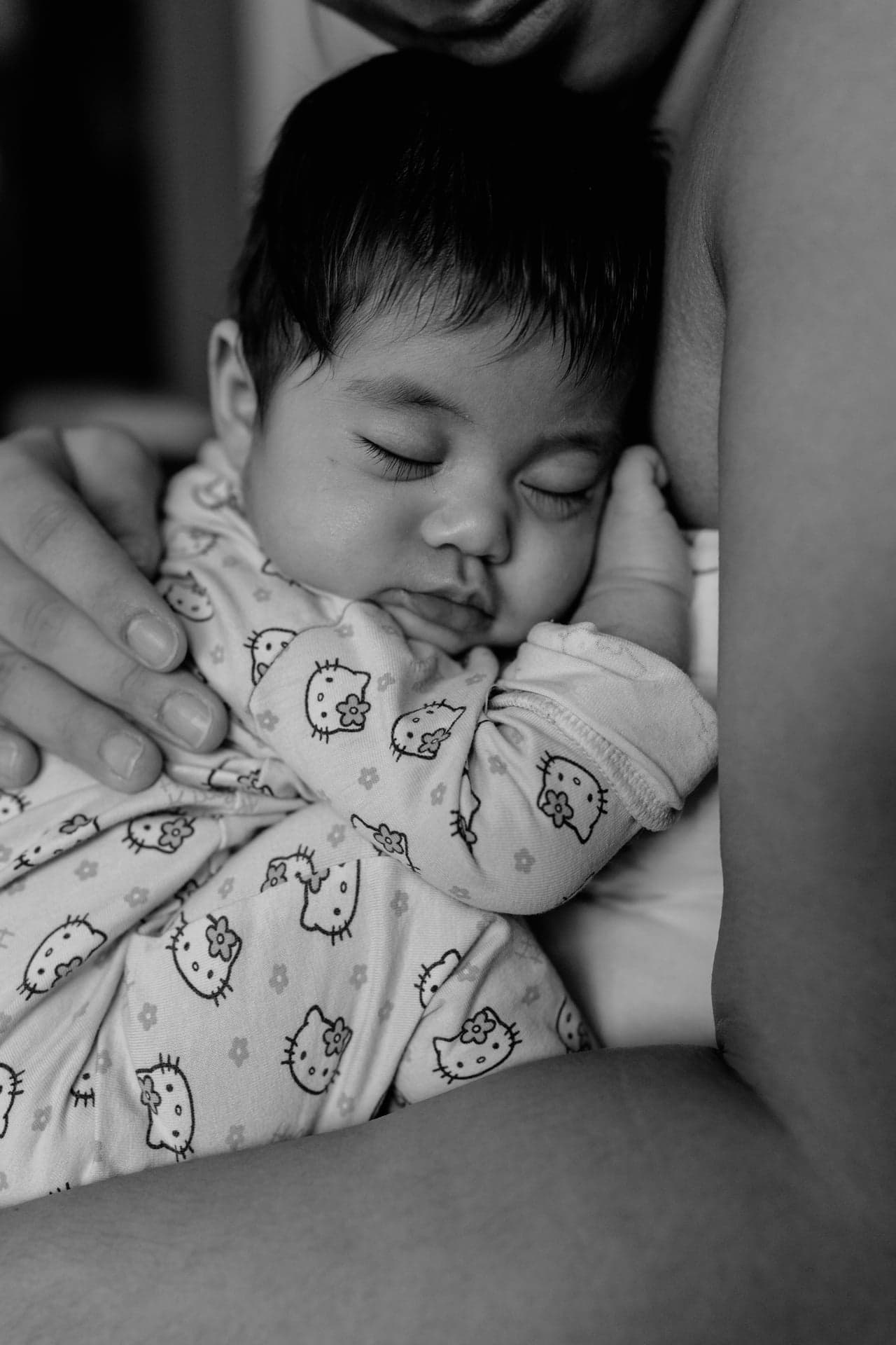 Newborn Shooting Wien – Baby schläft in Elternarmen